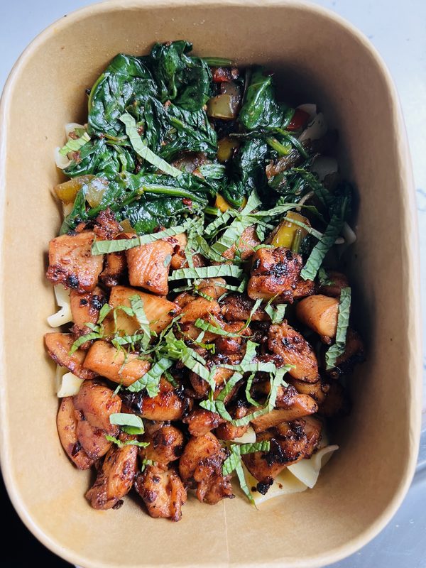 Charred chicken with sautéed greens and fresh herbs