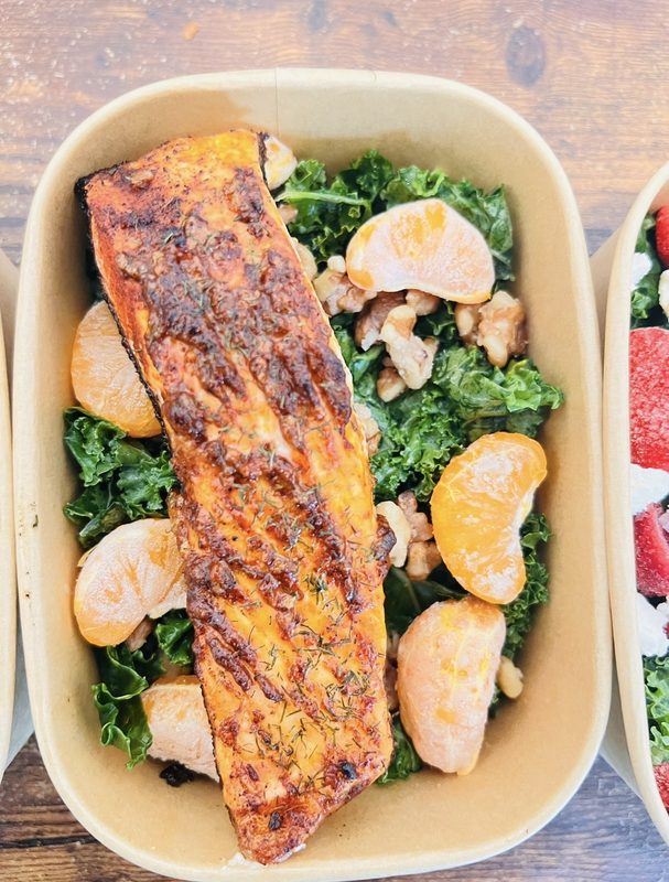 Seared salmon over kale salad with mandarin and walnuts